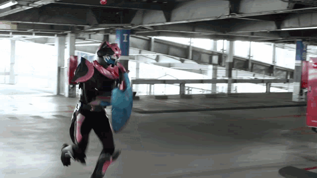 a person holding a blue shield in a parking garage with a sign that says i on it