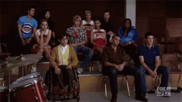 a cheerleader in a wmhs uniform is screaming in a crowd of people .
