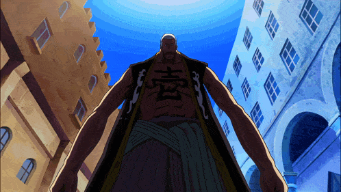 a man with chinese writing on his chest is standing in front of buildings