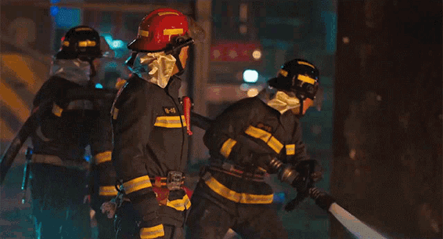a group of firefighters with one wearing a helmet that says 16-18