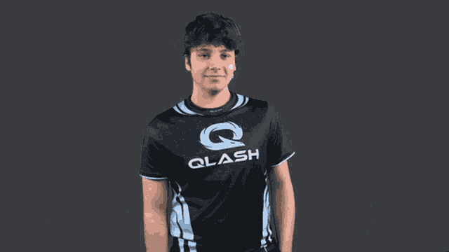 a young man wearing a black shirt that says qlash on it