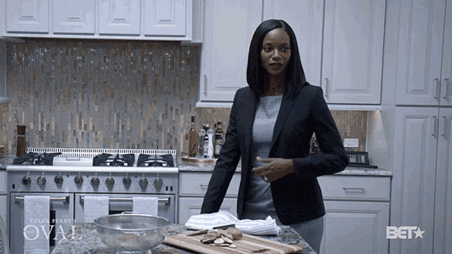 a woman stands in a kitchen with a bet star on the counter
