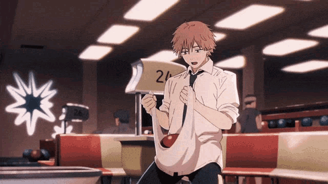 a man in a white shirt and tie is sitting in a bowling alley near the number 24