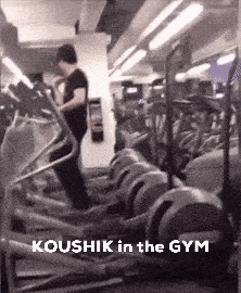 a man is walking on an elliptical in a gym .
