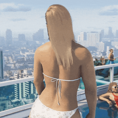 a woman in a bikini is standing on a balcony overlooking the city