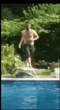 a shirtless man is jumping into a pool