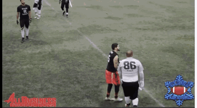 a group of men are playing a game of indoor soccer with a logo for all business productions