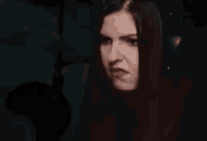 a close up of a woman making a funny face .