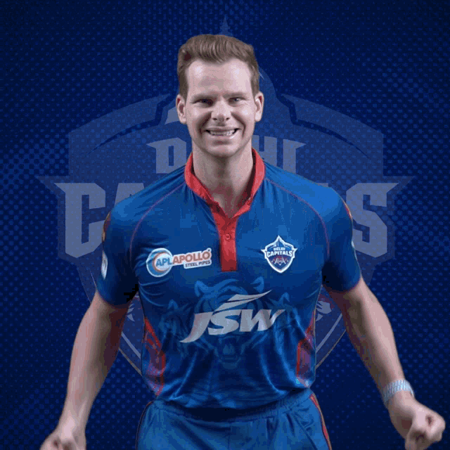a man wearing a blue shirt with the word capitals on the front
