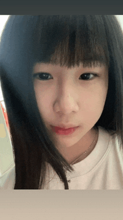 a close up of a girl 's face with a necklace around her neck