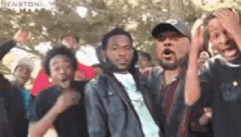 a group of men are standing next to each other in a park .