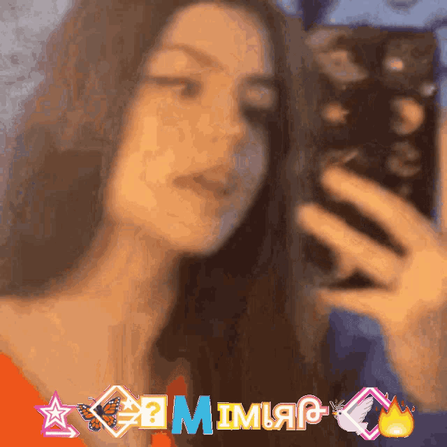 a blurry picture of a woman taking a selfie with the name mimiar written in the corner