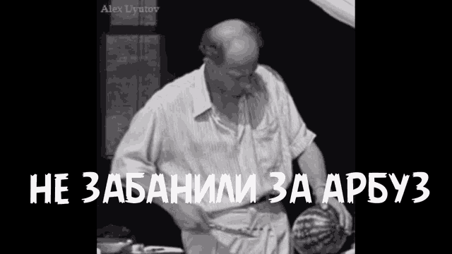 a man is cutting a watermelon with a knife in a black and white photo