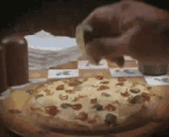 a pizza with a lot of toppings is being eaten