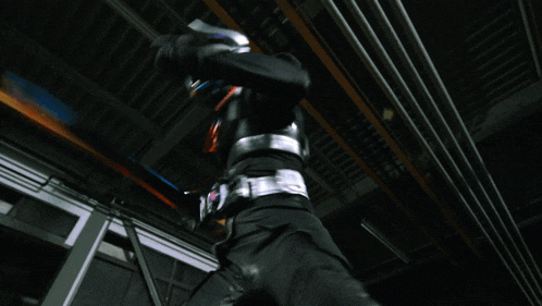 a person in a black suit is holding a sword