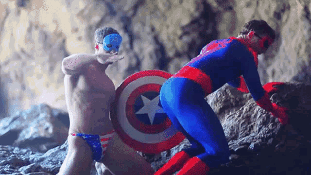 a man in a captain america costume is standing next to another man