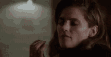 a close up of a woman 's face in a dark room .