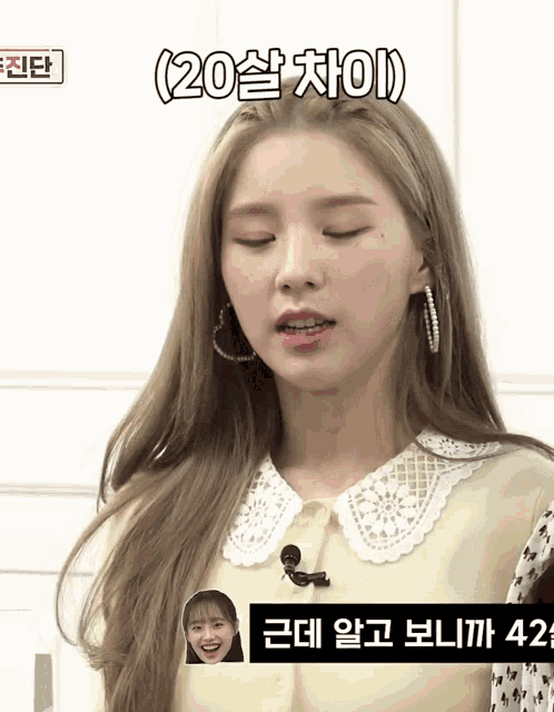 a woman with her eyes closed and a sign that says 20