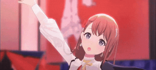 a girl with red hair and blue eyes is standing in front of a red wall with her arms in the air .