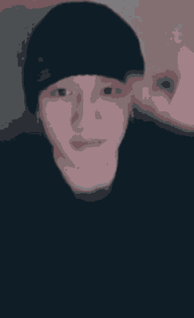 a close up of a person 's face with a black background .