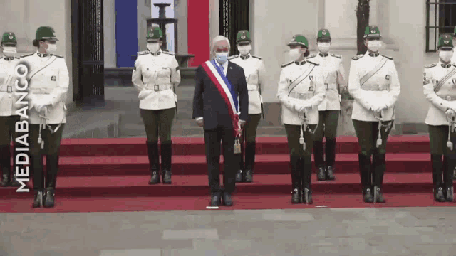 a man wearing a mask stands in front of a group of soldiers with the word mediabanco on the bottom