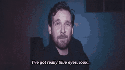 a man with a beard is talking about having blue eyes .