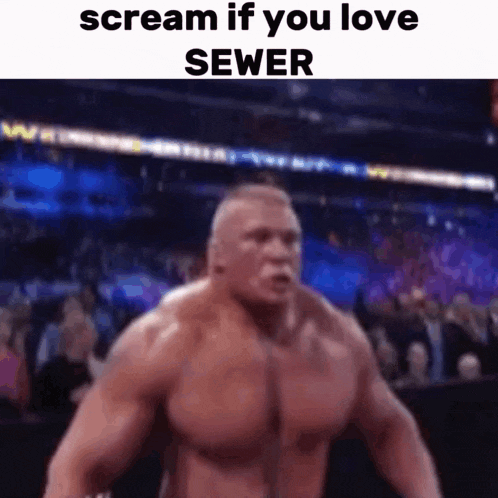 a very muscular man is screaming in front of a crowd while standing in front of a sewer .