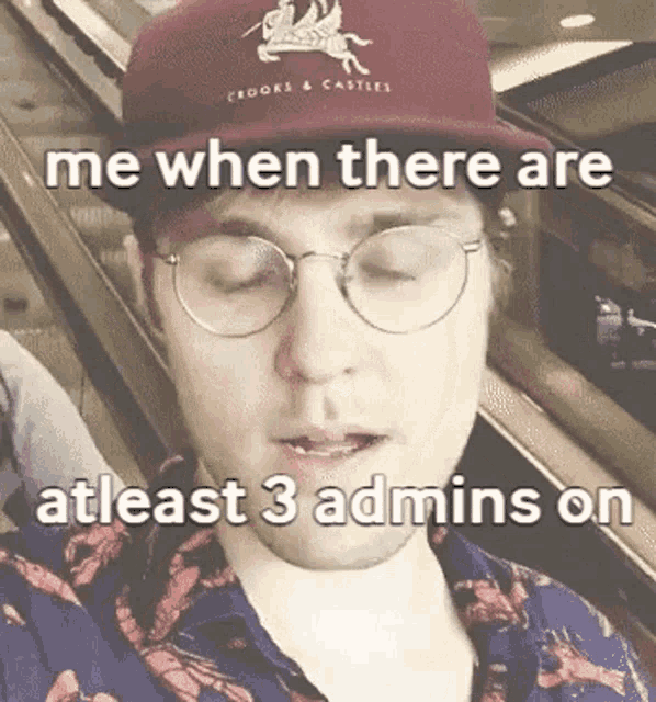 a man wearing glasses and a hat says me when there are atleast 3 admins on an escalator .