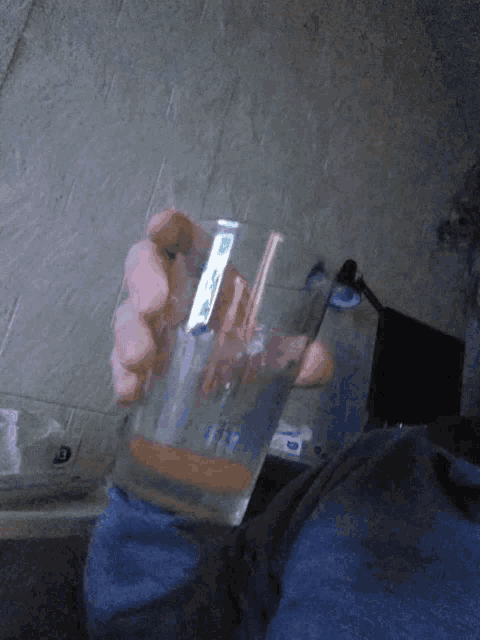 a person holding a glass with a sticker on it that says ' i 'm ' on it