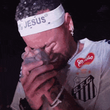 a man wearing a headband with jesus on it