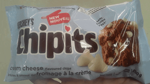 a person is holding a bag of hershey 's chipits cream cheese flavoured chips