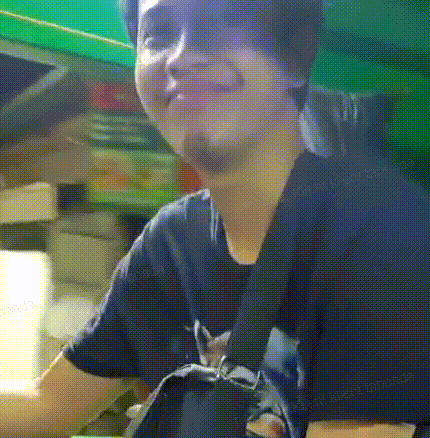 a man wearing a black t-shirt with a cat on it