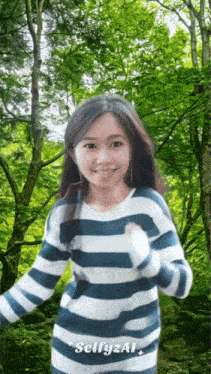 a girl in a blue and white striped sweater is standing in front of trees and the words selfyzal
