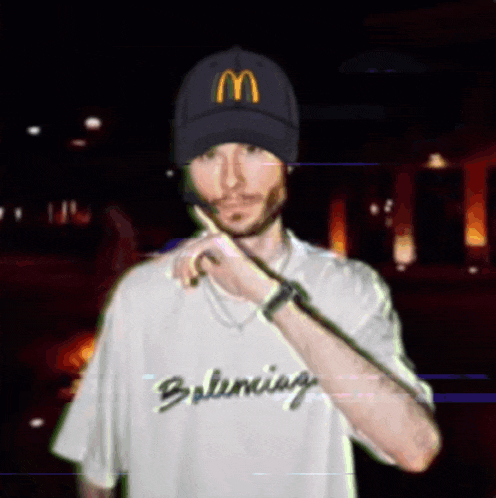 a man wearing a mcdonald 's hat and a balenciaga t-shirt