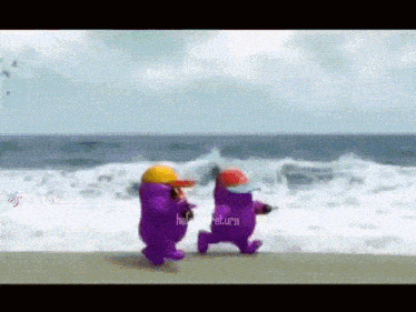 two purple among us characters are walking on a beach .