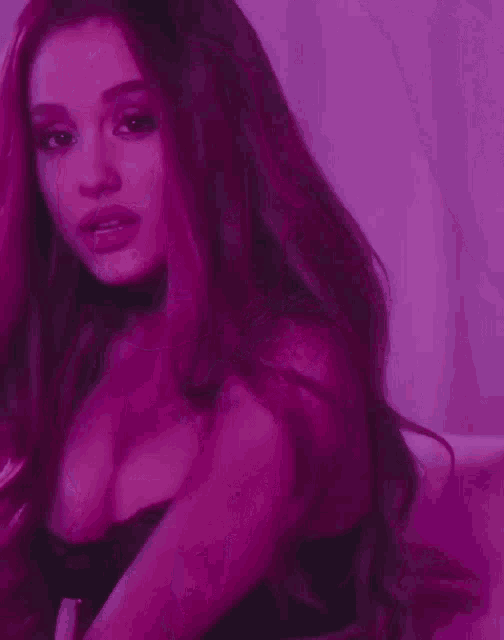 a woman with purple hair is wearing a choker and a black top
