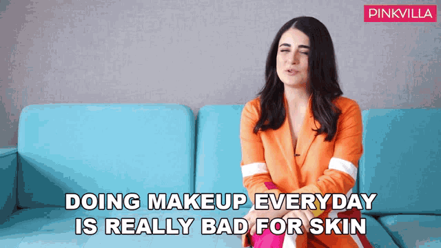 a woman sitting on a blue couch with the words doing makeup everyday is really bad for skin below her