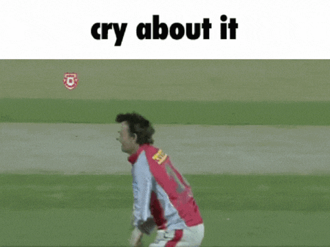 a man in a red shirt is running on a field with the caption " cry about it "