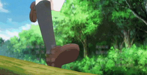 a person 's feet are shown walking across a grassy area
