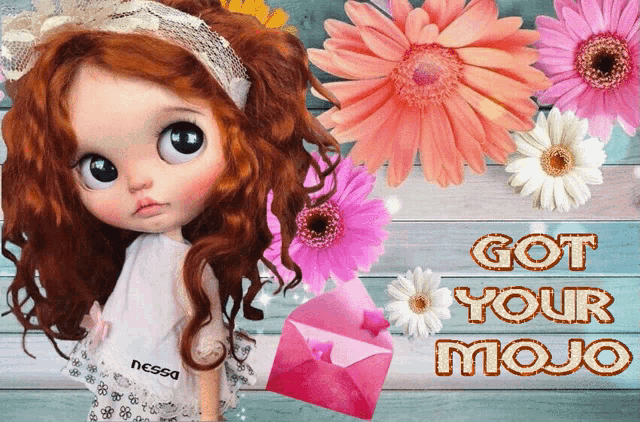 a doll is holding a pink envelope with the words got your mojo written on it