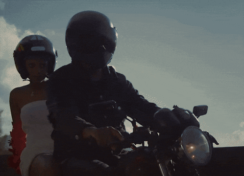 a man wearing a helmet is riding a motorcycle
