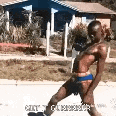a shirtless man is walking down a sidewalk in front of a house and says `` get it gurrrr '' .