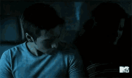 a man and a woman are sitting in the back seat of a car kissing .