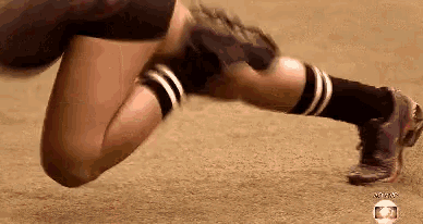 a person is doing push ups on the ground with a globe in the background .