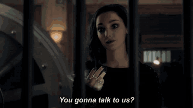 a woman behind bars with the words you gonna talk to us