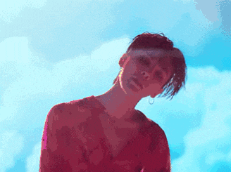 a woman in a red dress stands in front of a blue sky