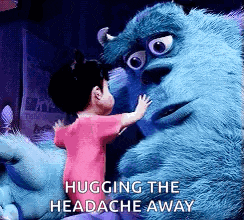 a little girl hugging a monster from monsters inc .
