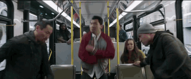 a group of people are sitting on a bus and one of them is holding a baby .