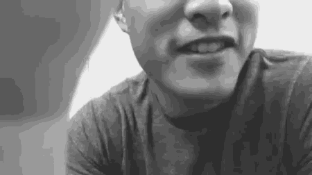 a black and white photo of a man 's face .