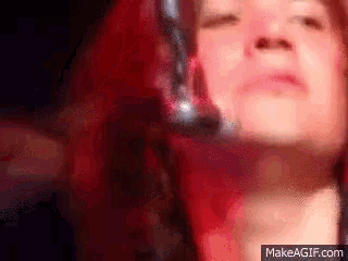 a close up of a woman 's face with headphones on